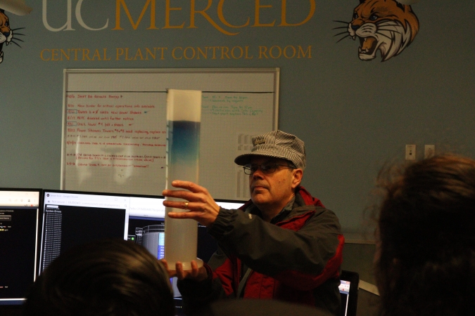 James Brugger, Director Of Campus Engineering Services, Central Plant, provides local elementary students with a lesson on the relationship between water density and temperature. 