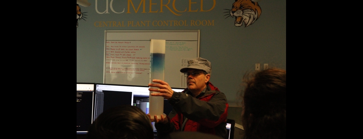 James Brugger, Director Of Campus Engineering Services, Central Plant, provides local elementary students with a lesson on the relationship between water density and temperature. 